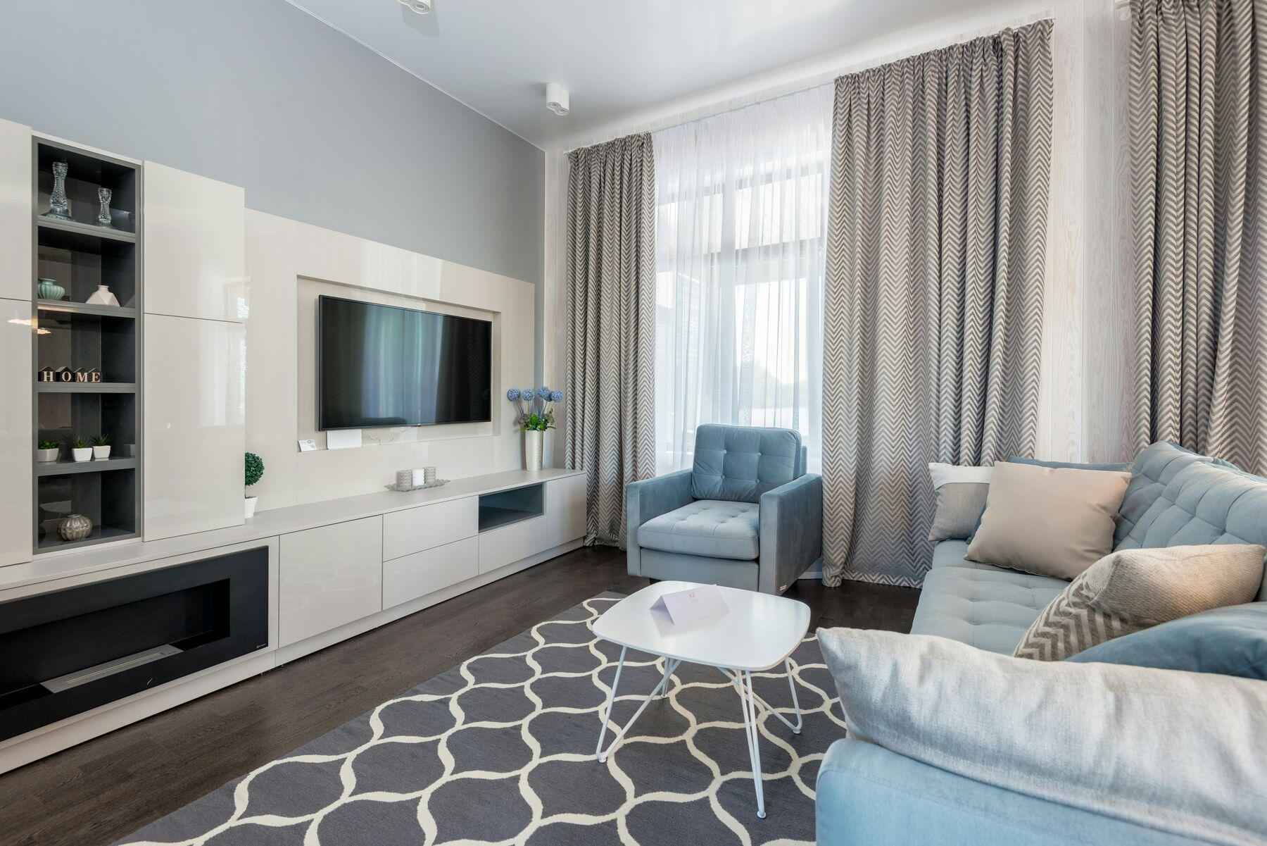 Living room with grey chevron curtains and white sheers