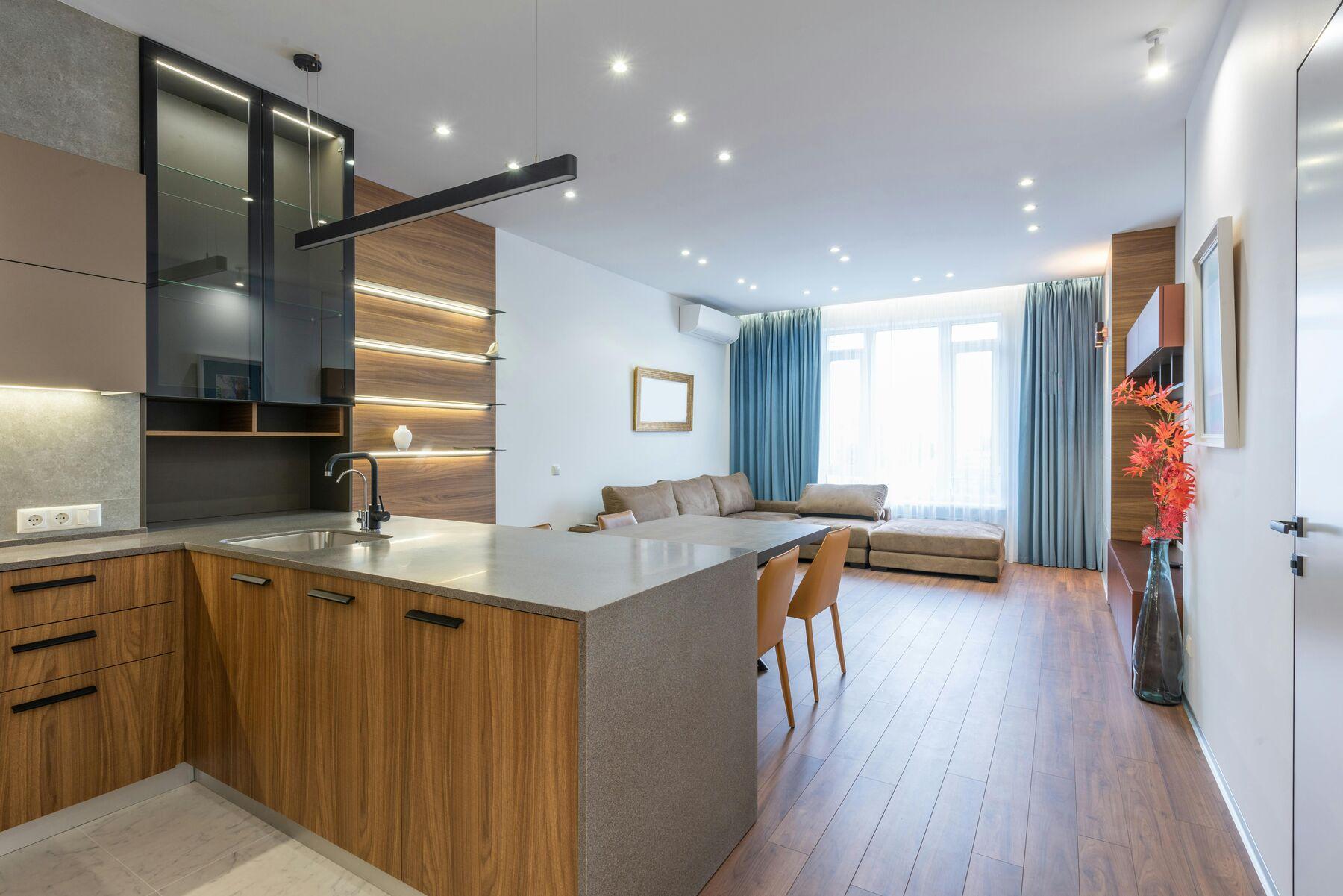 Open-plan living room with full-length blue curtains